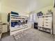 A bedroom featuring carpet, neutral walls, a bunk bed, a barn-door wardrobe, and natural light at 9832 Kenton Cir, Commerce City, CO 80022