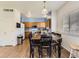 Bright eat-in kitchen featuring wooden cabinets, white appliances, and a dining area at 9832 Kenton Cir, Commerce City, CO 80022