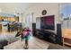 The living room has a modern entertainment center and offers a seamless flow to the eat-in kitchen at 9832 Kenton Cir, Commerce City, CO 80022