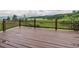 Well-maintained wooden deck offering expansive green field and mountain views at 5939 Lone Peak Dr, Evergreen, CO 80439