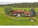 Scenic backyard view showcasing a well-kept lawn, stone retaining wall, and a deck, perfect for outdoor enjoyment at 5939 Lone Peak Dr, Evergreen, CO 80439