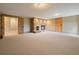 Open basement space with a stone fireplace and carpet flooring, ideal for relaxing at 5939 Lone Peak Dr, Evergreen, CO 80439