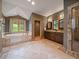 Oversized bathroom featuring a soaking tub, walk-in shower, and double vanity at 5939 Lone Peak Dr, Evergreen, CO 80439
