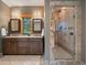 Bright bathroom boasts a walk-in shower and dual vanity with plenty of storage at 5939 Lone Peak Dr, Evergreen, CO 80439