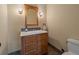 Cozy bathroom features a wooden vanity, marble countertop, and sconce lighting at 5939 Lone Peak Dr, Evergreen, CO 80439
