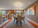 Elegant dining room with a chandelier, decorative rug, and natural light, ideal for entertaining at 5939 Lone Peak Dr, Evergreen, CO 80439