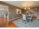 Well-lit dining room next to kitchen and stairs, with a large painting on the wall at 5939 Lone Peak Dr, Evergreen, CO 80439