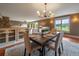Bright dining room with a wooden table, upholstered chairs, and scenic outdoor views at 5939 Lone Peak Dr, Evergreen, CO 80439