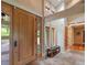 Bright entryway featuring a stone floor, wood bench, and a large door with glass panels at 5939 Lone Peak Dr, Evergreen, CO 80439
