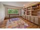 Inviting home office with built-in shelving, and hardwood flooring at 5939 Lone Peak Dr, Evergreen, CO 80439