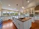 Bright kitchen with marble island, custom cabinets, and views of the surrounding hills at 5939 Lone Peak Dr, Evergreen, CO 80439