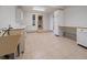 Bright laundry room offering ample counter space, modern cabinets, and neutral tile flooring at 5939 Lone Peak Dr, Evergreen, CO 80439