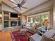 Comfortable living room with fireplace, skylight, and built-in shelving at 5939 Lone Peak Dr, Evergreen, CO 80439