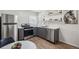 Modern kitchen featuring stainless steel appliances, gray cabinets, and stylish shelving at 5008 Alcott St, Denver, CO 80221