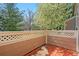 View of the back patio with wood-slat walls and mature trees at 4069 S Abilene Cir # E, Aurora, CO 80014