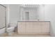 Neutral bathroom features a large mirror, vanity with storage, and a toilet at 4069 S Abilene Cir # E, Aurora, CO 80014