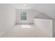 Bright bedroom featuring neutral carpet, a window, and freshly painted white walls at 4069 S Abilene Cir # E, Aurora, CO 80014