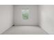 Neutral bedroom with light carpet, a window, and freshly painted walls at 4069 S Abilene Cir # E, Aurora, CO 80014