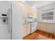 Functional kitchen featuring white appliances and hardwood flooring at 4069 S Abilene Cir # E, Aurora, CO 80014
