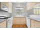 Cozy kitchen with wooden floors, white appliances, a window over the sink, and tile backsplash at 4069 S Abilene Cir # E, Aurora, CO 80014