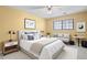 A bright bedroom features neutral walls, a large window and a bed adorned with a mix of pillows at 12622 E Warren Dr # E, Aurora, CO 80014