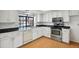 Well-lit kitchen featuring white cabinets, stainless steel appliances, and a stylish countertop at 12622 E Warren Dr # E, Aurora, CO 80014