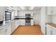 Bright kitchen with white cabinets, stainless steel appliances, and modern countertops at 12622 E Warren Dr # E, Aurora, CO 80014