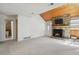 Spacious living room with a stone fireplace, wood ceiling, and a view of the bathroom at 12622 E Warren Dr # E, Aurora, CO 80014