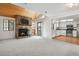 Comfortable living area featuring a stone fireplace, wood ceiling, and an adjacent kitchen at 12622 E Warren Dr # E, Aurora, CO 80014