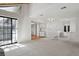 Bright living room with large windows and seamless access to the kitchen and staircase at 12622 E Warren Dr # E, Aurora, CO 80014
