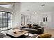 Bright living room with large windows, hardwood floors, and comfortable gray sofa at 12622 E Warren Dr # E, Aurora, CO 80014
