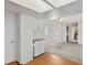 Open living space with white cabinetry, wood floors, and access to additional rooms at 12622 E Warren Dr # E, Aurora, CO 80014