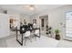 Bright office with a black desk, white chairs, and indoor plants on a patterned rug at 12622 E Warren Dr # E, Aurora, CO 80014