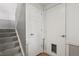 Neutral stairway leading to an upper level with a closed door with a pet opening at 12622 E Warren Dr # E, Aurora, CO 80014