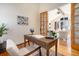 Inviting home office with wood desk, globe, and a view to the living room at 2416 Fossil Trace Dr, Golden, CO 80401