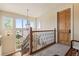 Staircase with iron railing and natural light from large windows at 2416 Fossil Trace Dr, Golden, CO 80401