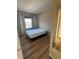 Clean bedroom with hardwood floors, natural light, and neutral decor at 7414 E 28Th Ave # 4, Denver, CO 80238