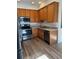Bright kitchen featuring stainless steel appliances, wood cabinets, and sleek countertops at 7414 E 28Th Ave # 4, Denver, CO 80238