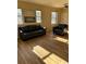 Inviting living room with modern floors, bright windows and comfortable leather sofa and chair at 7414 E 28Th Ave # 4, Denver, CO 80238