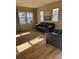 Bright living room with hardwood floors, large windows, and comfortable leather seating at 7414 E 28Th Ave # 4, Denver, CO 80238