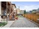 Small, fenced backyard with gravel and wooden deck at 1331 N Ogden St # 1, Denver, CO 80218