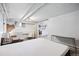 Basement bedroom featuring exposed brick, an adjacent kitchen, and a neutral color palette at 1331 N Ogden St # 1, Denver, CO 80218