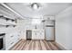 Modern basement kitchen with white cabinets, a farmhouse sink, and stylish backsplash at 1331 N Ogden St # 1, Denver, CO 80218