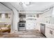 Modern kitchen featuring stainless steel appliances, white cabinets, and stylish wood-look flooring at 1331 N Ogden St # 1, Denver, CO 80218