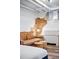 Living area showcasing sofa, ottomans, brick accent wall, and natural lighting at 1331 N Ogden St # 1, Denver, CO 80218