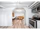 Living space with stylish furniture and a kitchen area, featuring exposed brick at 1331 N Ogden St # 1, Denver, CO 80218