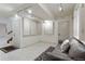 Finished basement with a couch and built-in shelving at 4773 W Easter Ct, Littleton, CO 80128