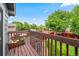 Backyard view from a private balcony, with green lawn, mature trees, and a wood fence at 12545 Elm St, Thornton, CO 80241