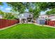 Beautiful backyard with lush green grass, a charming patio, and a storage shed with decorative artwork at 12545 Elm St, Thornton, CO 80241