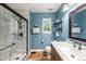 Modern bathroom featuring a glass-enclosed shower, neutral color palette, and vanity with quartz countertop at 12545 Elm St, Thornton, CO 80241